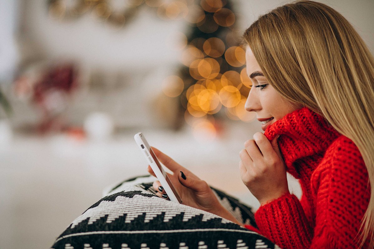 young-woman-using-phone-christmas_optimized.jpg